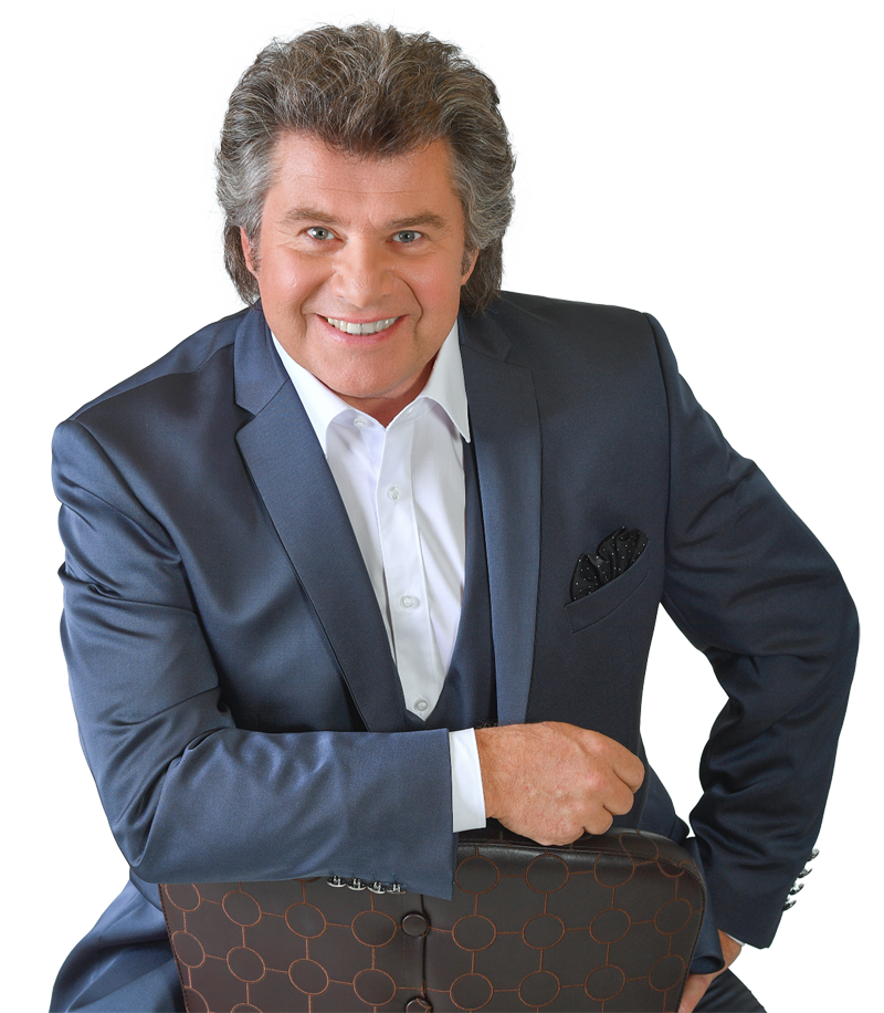 Andy Borg im eleganten Anzug mit weißem Hemd auf einem Pressefoto